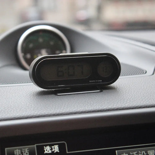 Black car electronic clock and thermometer with LED display on adjustable dashboard bracket