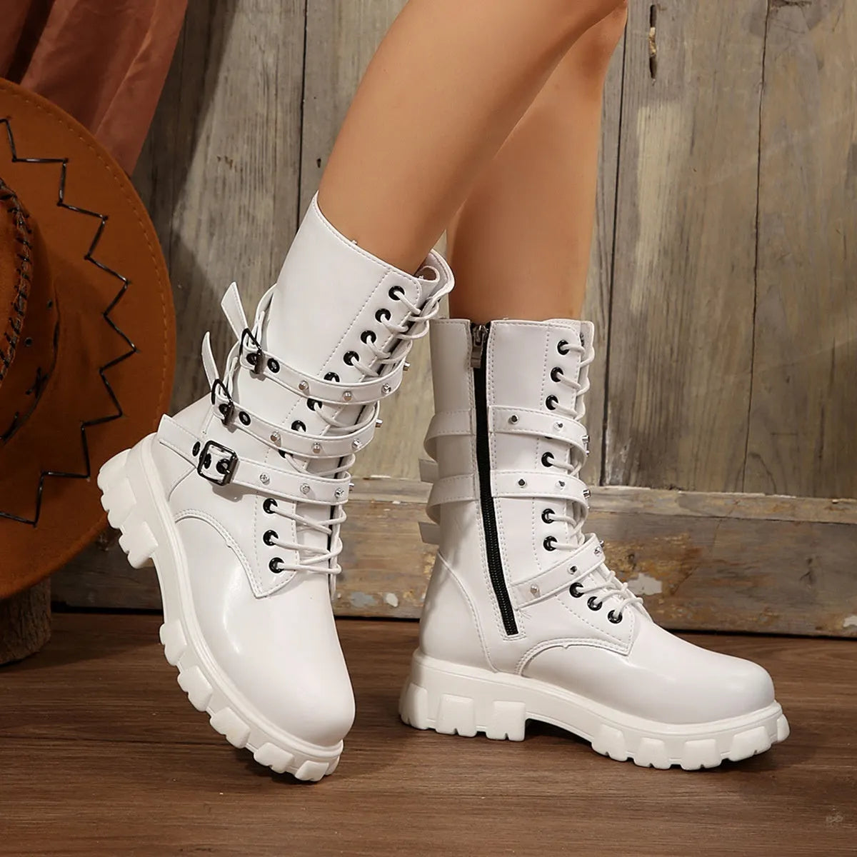 Women's black mid-calf boots with a metal buckle strap and side zipper, made of artificial PU leather.