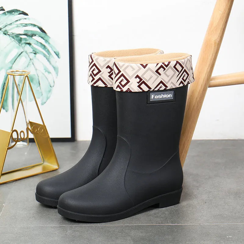 Women's mid-calf PVC rain boot in black, shown with a low heel and optional wool lining.