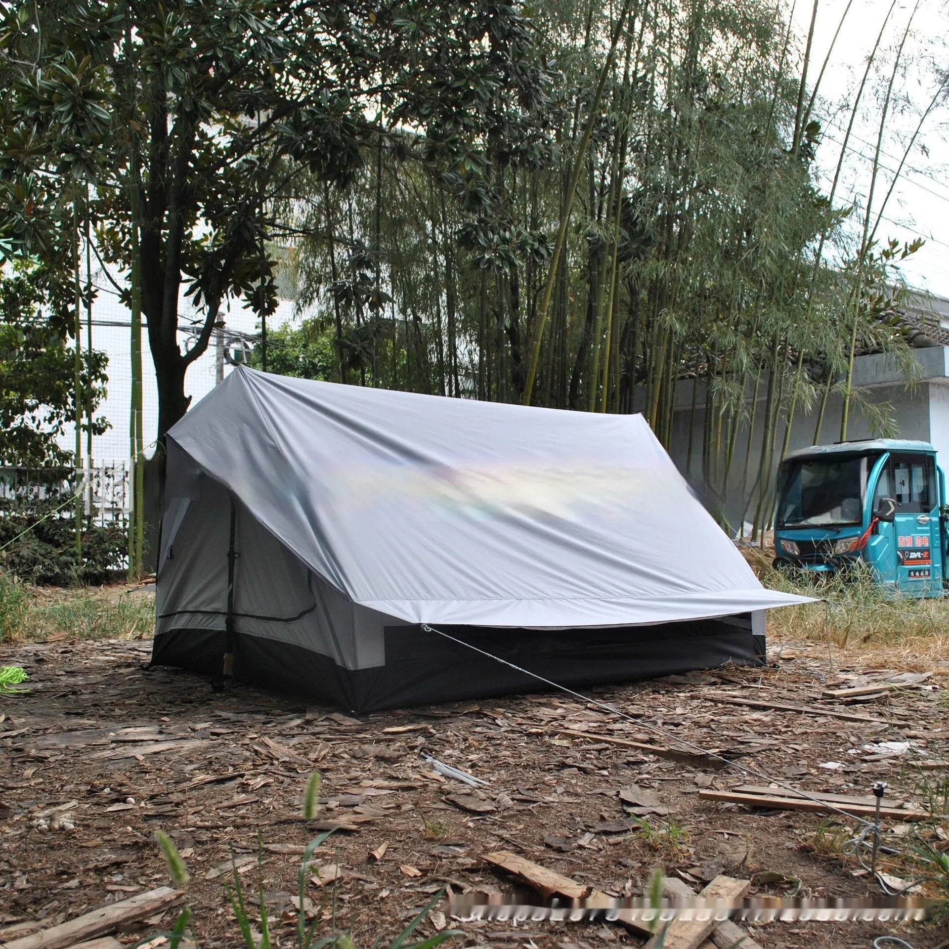 Brown or white A-line cabin tent using hiking canes for support with dimensions 210x150x110cm