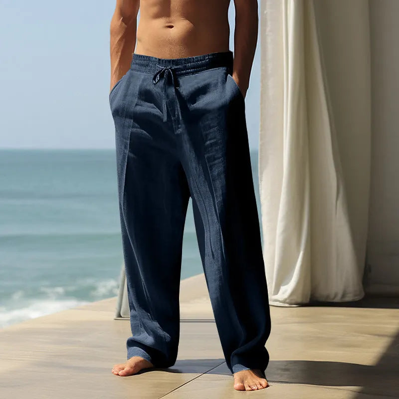 Men's cotton casual trousers with elastic waistband in seven solid colours showing loose fit design