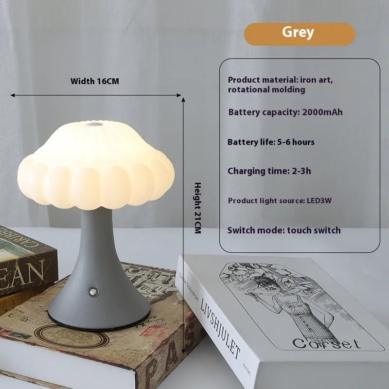 Small mushroom-shaped touch control night light in wood grain finish on a wooden table