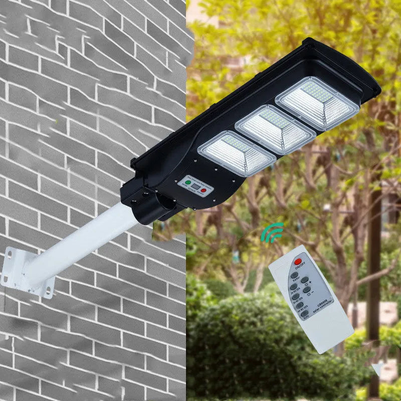 Integrated solar-powered street light with LED panel and remote control for outdoor use.