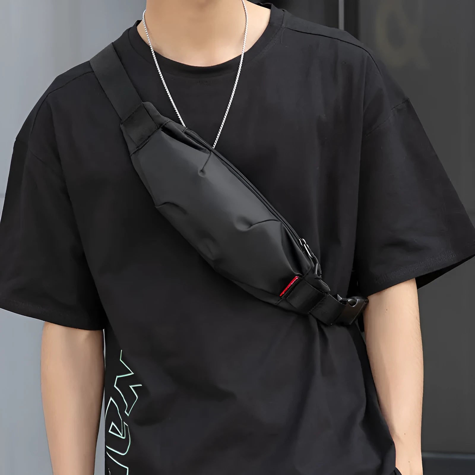 Black oxford cloth men's waist pack with crossbody strap, showing phone and ID pockets.