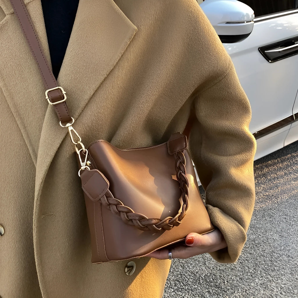 Retro woven PU leather crossbody bucket bag in khaki colour showing underarm design and textured surface