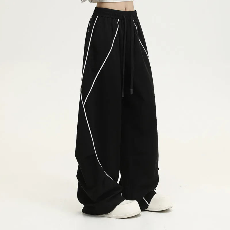 Black pleated wide-leg hip hop pants with striped pattern and mid waist, loose fit polyester streetwear trousers