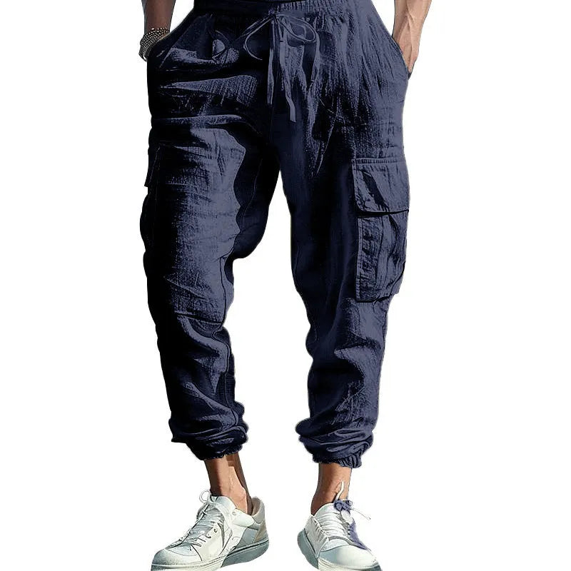 Men's solid colour linen casual trousers with ankle-tied cuffs, multiple pockets, and a drawstring waist