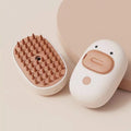White rechargeable steam pet brush with rubber comb teeth and water tank for grooming dogs and cats.