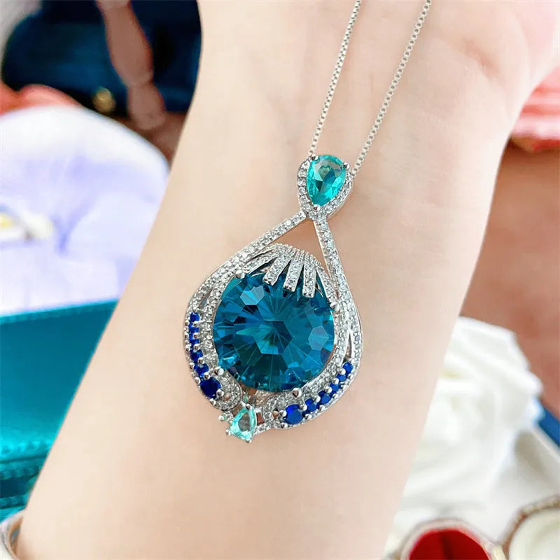 Women's geometric pendant necklace with blue crystal gemstone and water wave chain design
