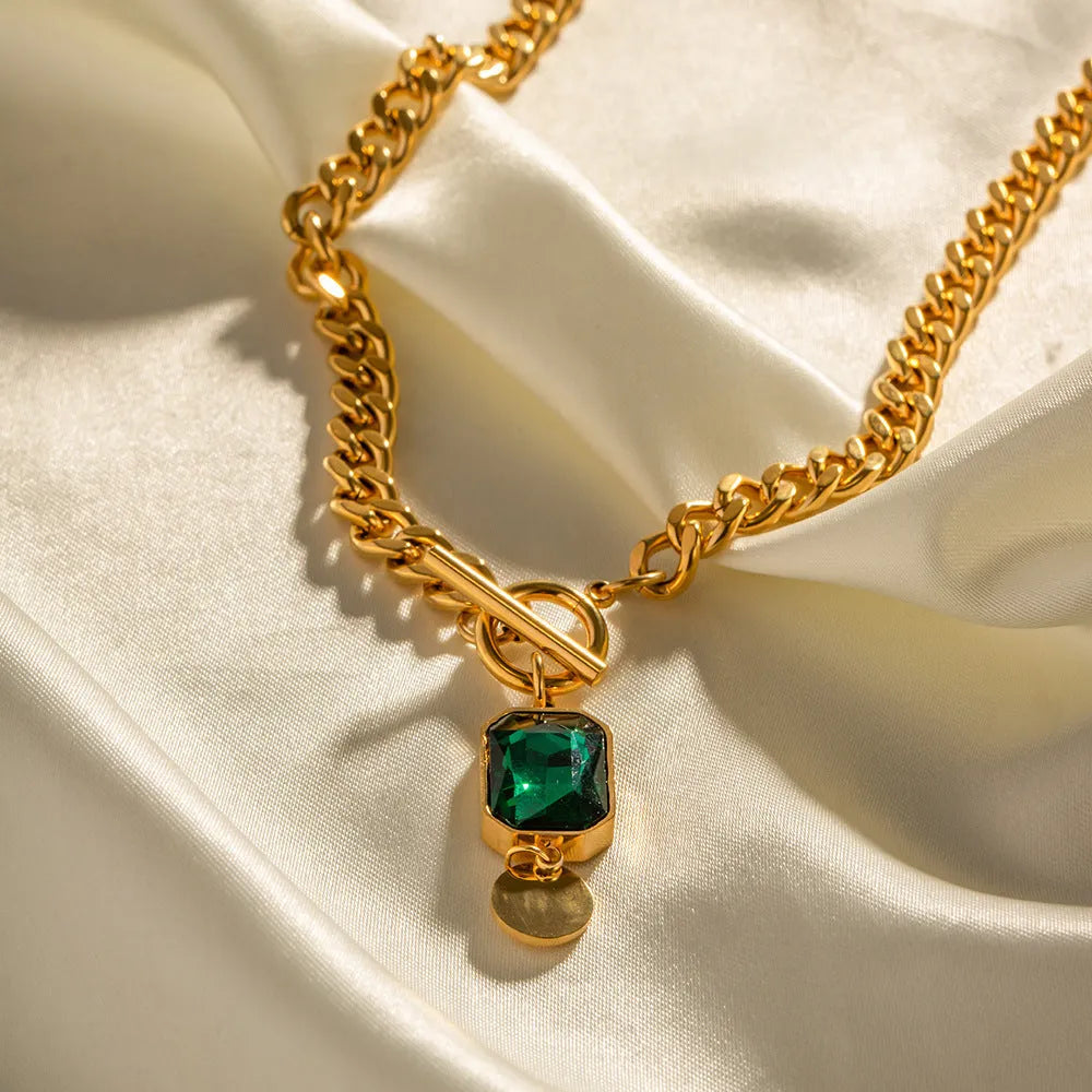 Gold coloured geometric zircon pendant necklace on a Cuban link chain for women.