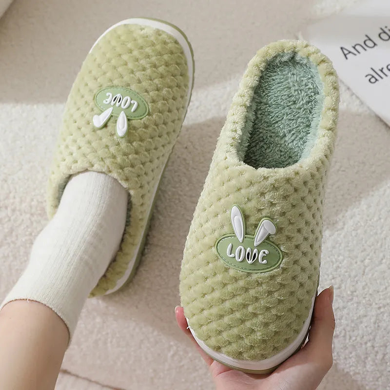 Rabbit plaid design women's house slippers in artificial fur with a flat heel and rubber sole.