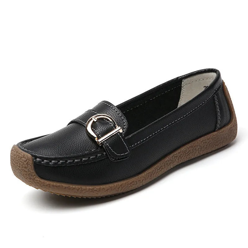 Women's beige loafers with round toe and flat heel on a light background