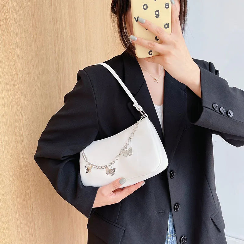 Women's black PU butterfly chain underarm handbag with crossbody strap, shown in a horizontal square shape.