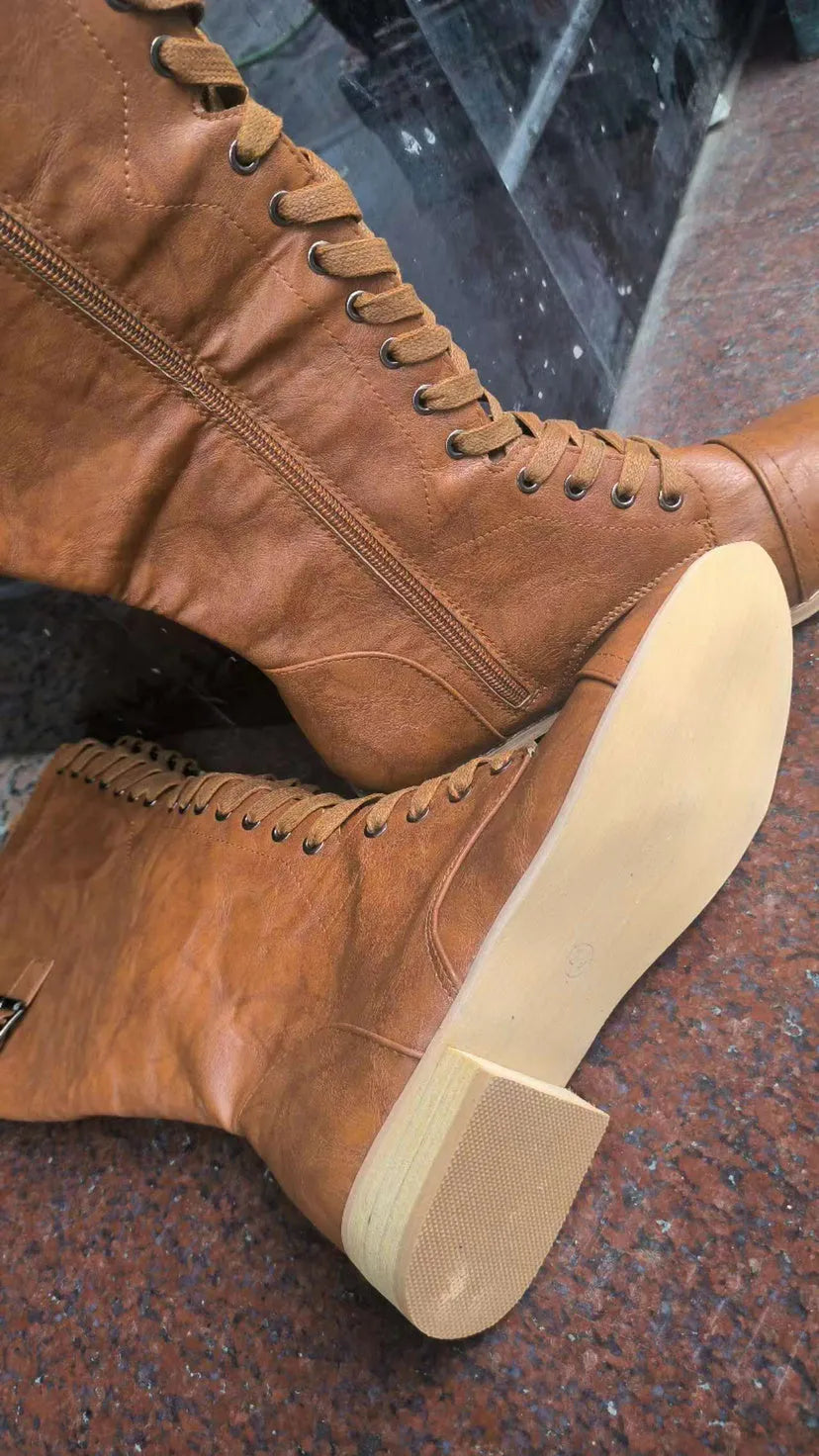 Women's black knight ankle boots with a cross strap design over the instep.