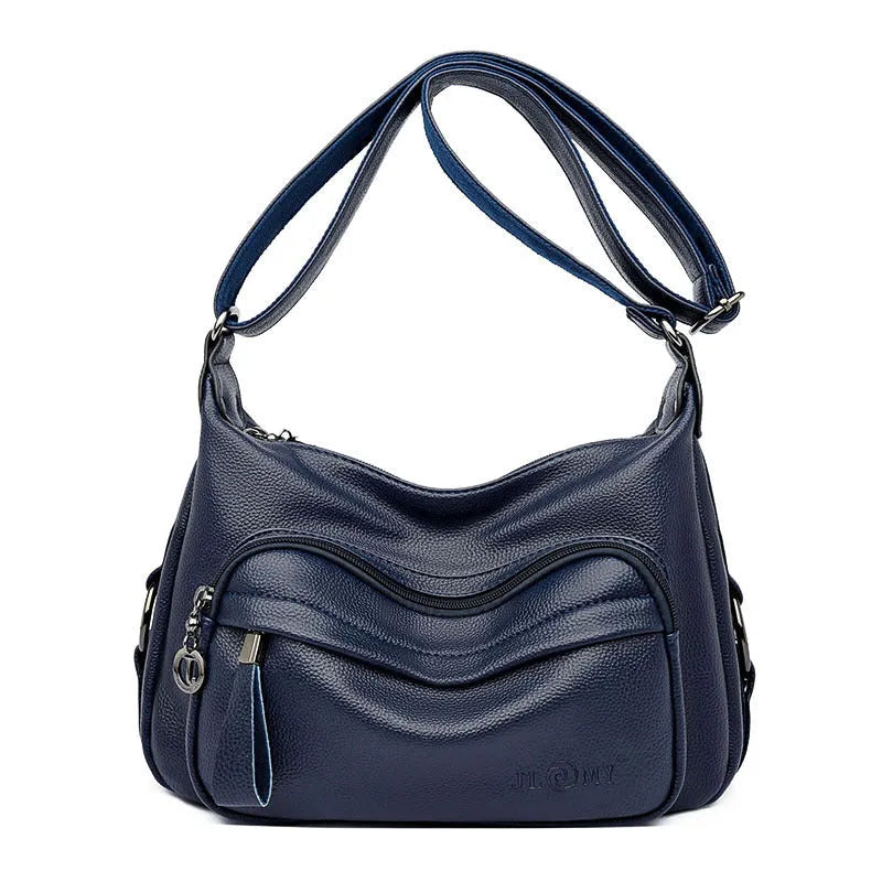 Women's blue soft PU crossbody bag showing interior phone and document compartments with zipper closure