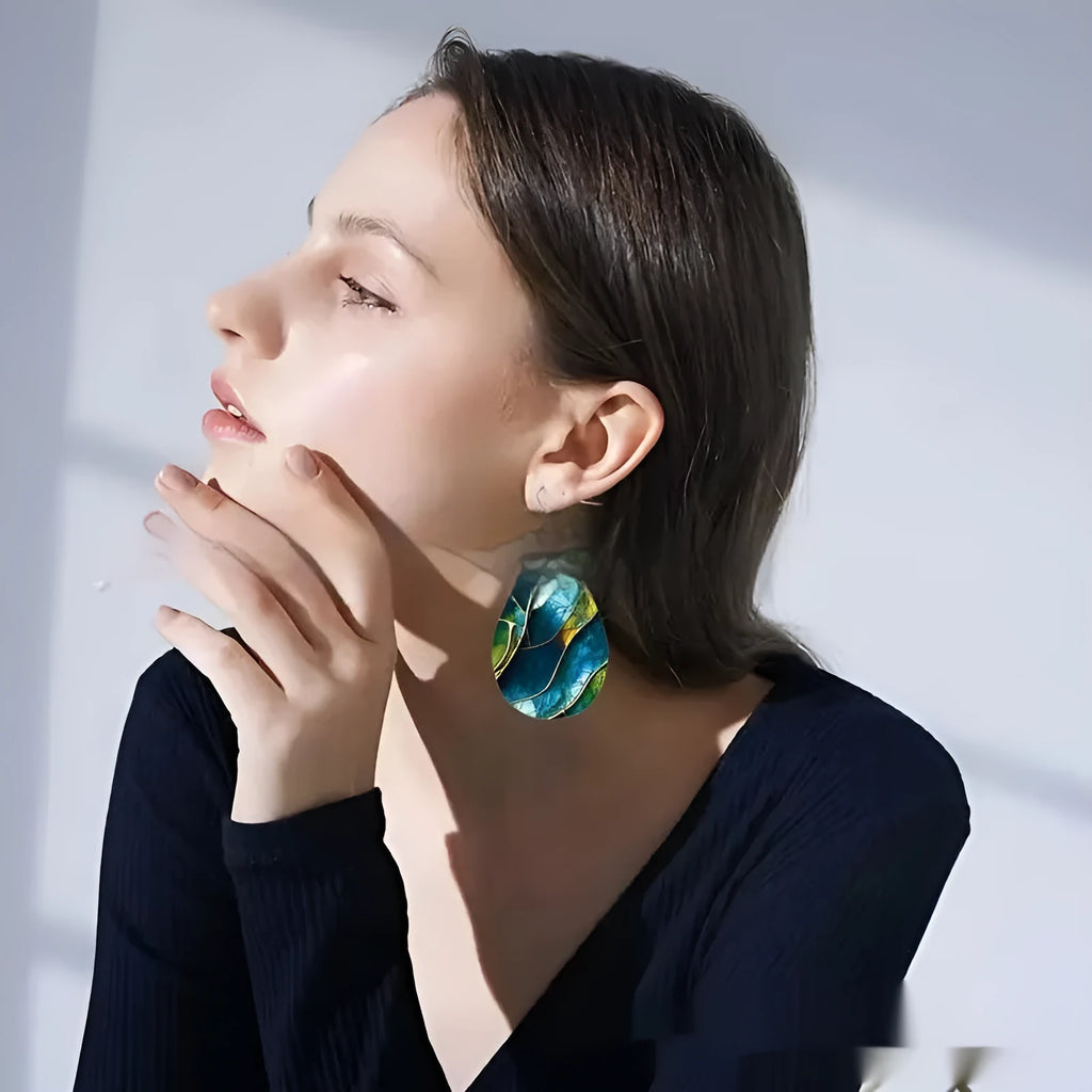 Clear acrylic drop earrings with flat branch knot design, front view