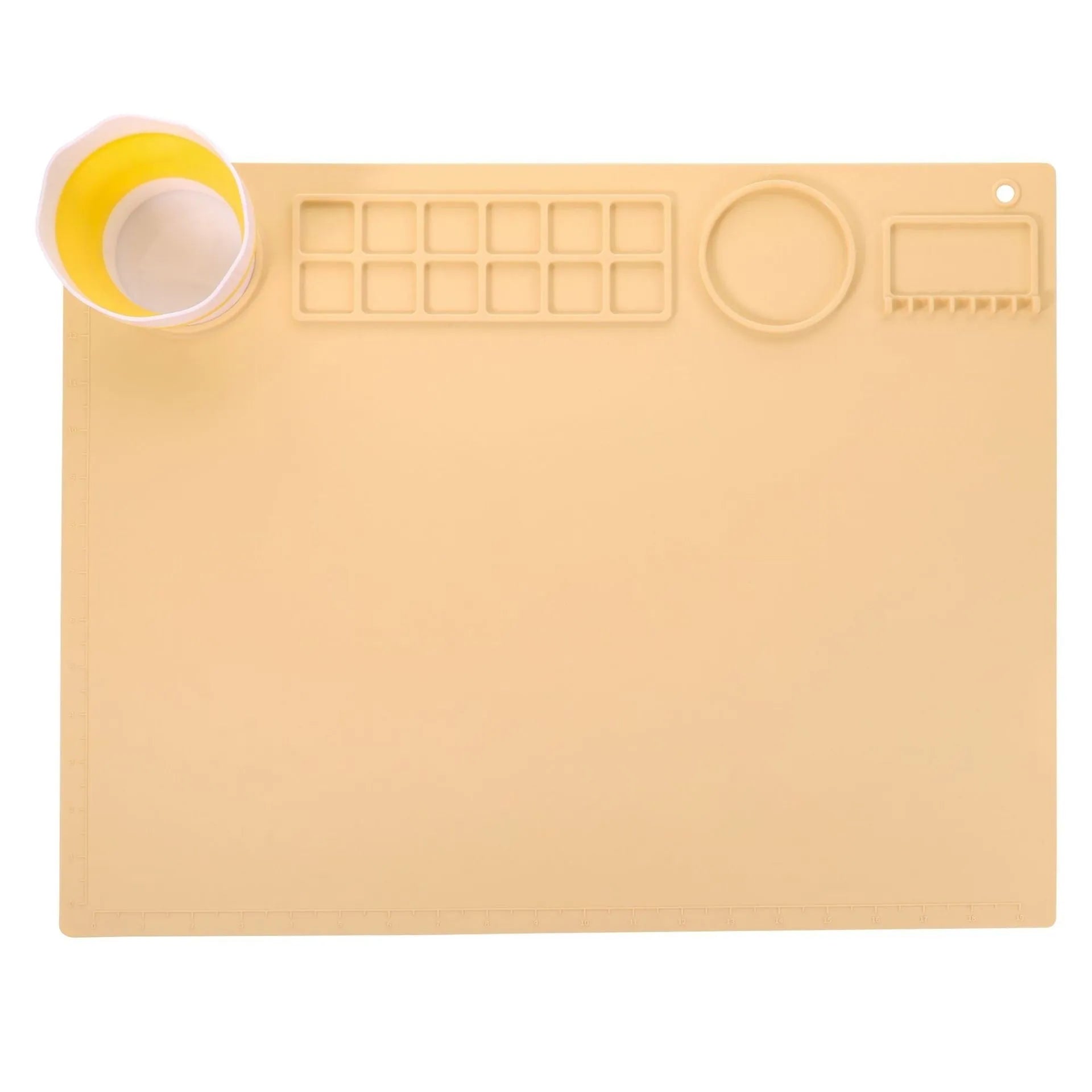 Green silicone painting mat measuring 50 by 40 centimetres with two round bowl wells for holding water or paint.