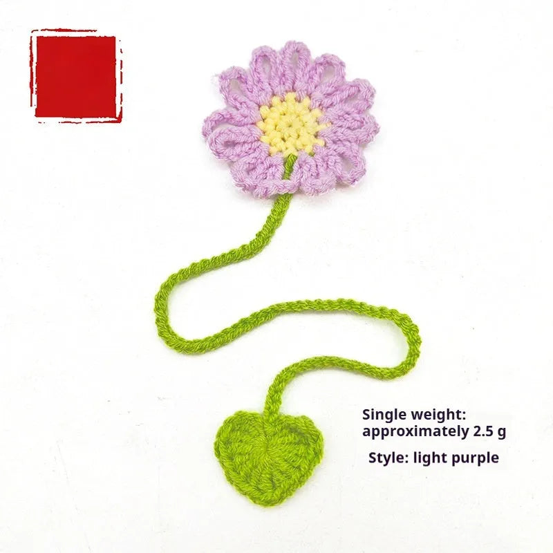 Hand-crocheted daisy flexible wire bookmark in yellow, pink, light purple, and orange colours.