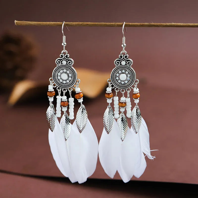 Round drop feather earrings with leaf detailing in various bohemian colours