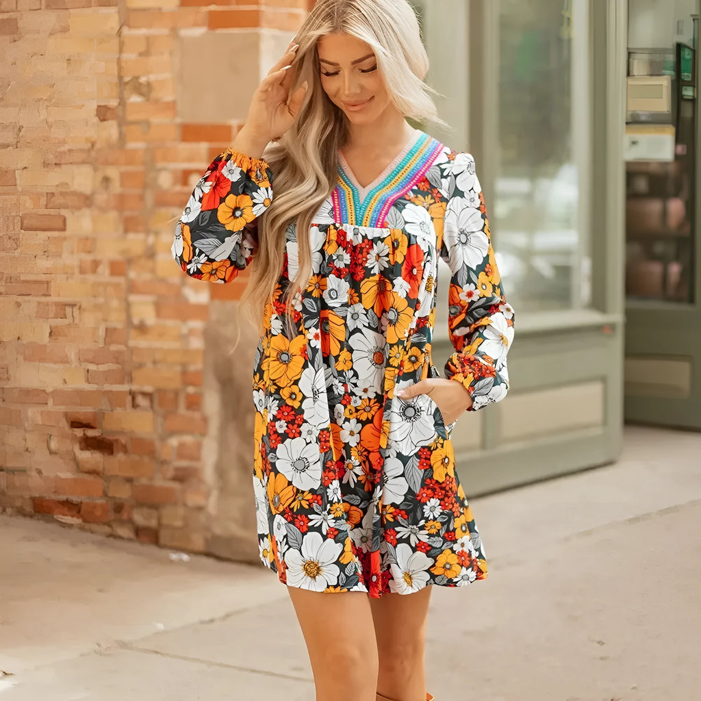 Orange floral print mini dress with striped and lace long sleeves and a V neckline.