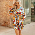 Orange floral print mini dress with striped and lace long sleeves and a V neckline.
