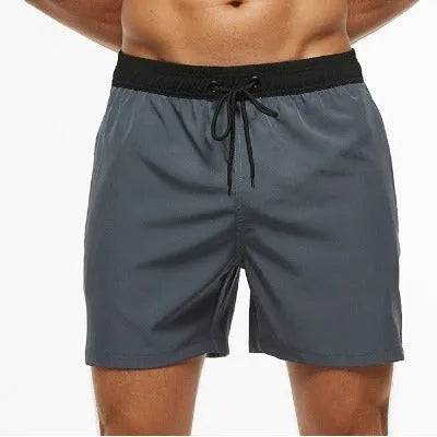 Men's blue drawstring athletic shorts with a zipper pocket and stitching detail on the waistband