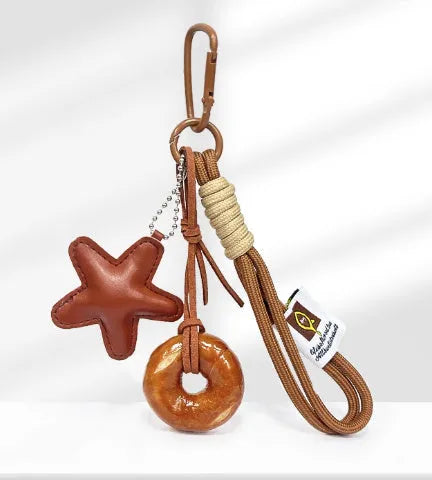 Handbag pendant charm with handmade soda bread design patterns including brown star, croissant, and bagel