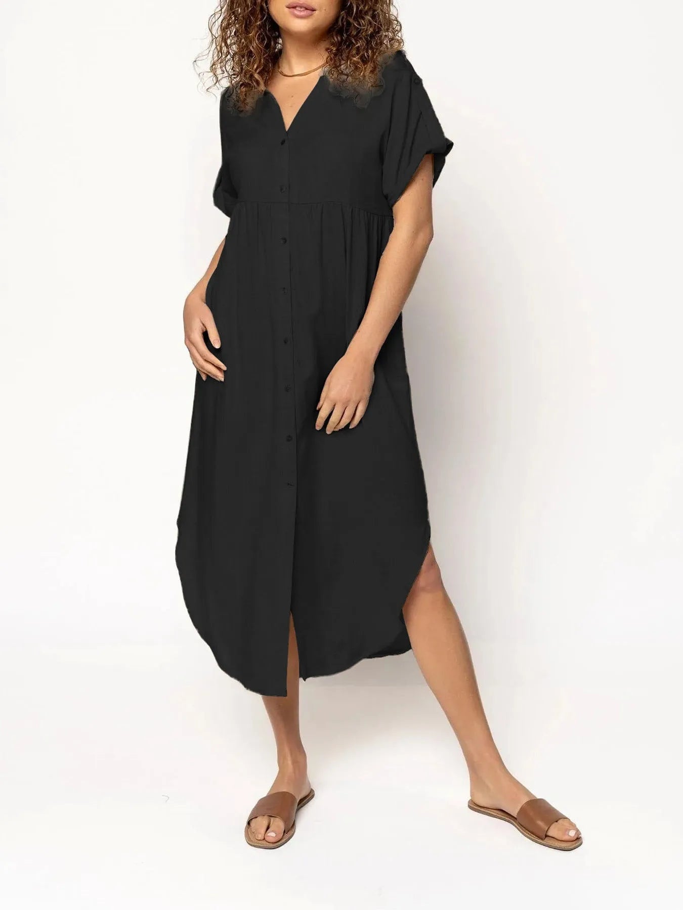A woman wearing a casual solid-colour mid-length dress with a button-down front.
