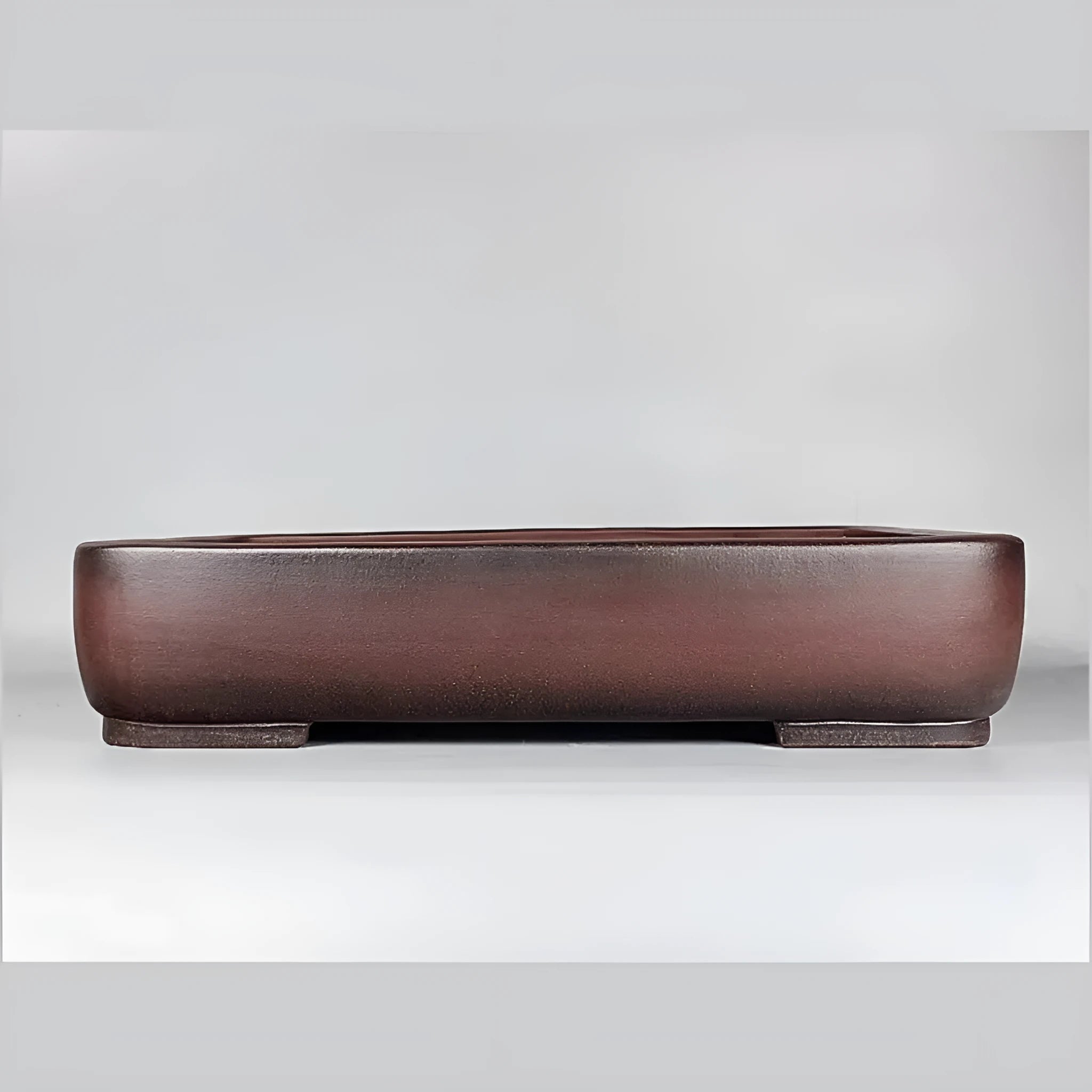 Handmade antique rectangular purple clay flower pot on tabletop