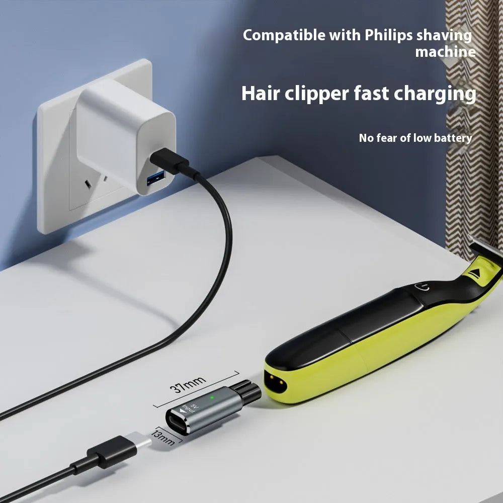 Black USB-C charging adapter for electric shavers and hair clippers on a grey background.