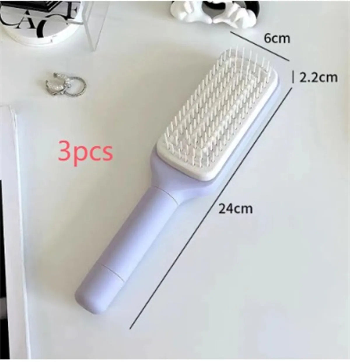 Roland purple and lunar rock grey self-cleaning hair brush with anti-static massage comb teeth.