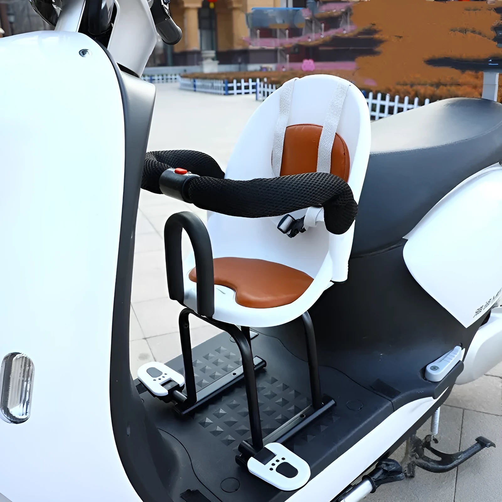 Front-mounted child safety seat for a battery scooter in black, red, or white.