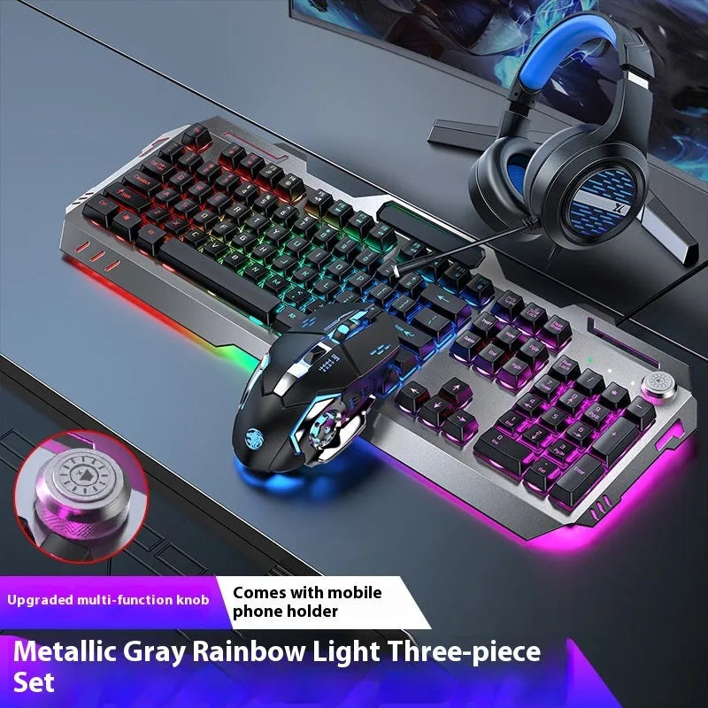 Aluminium gaming keyboard with volume knob, shown in metal grey with RGB lighting alongside optional macro mouse and headset.