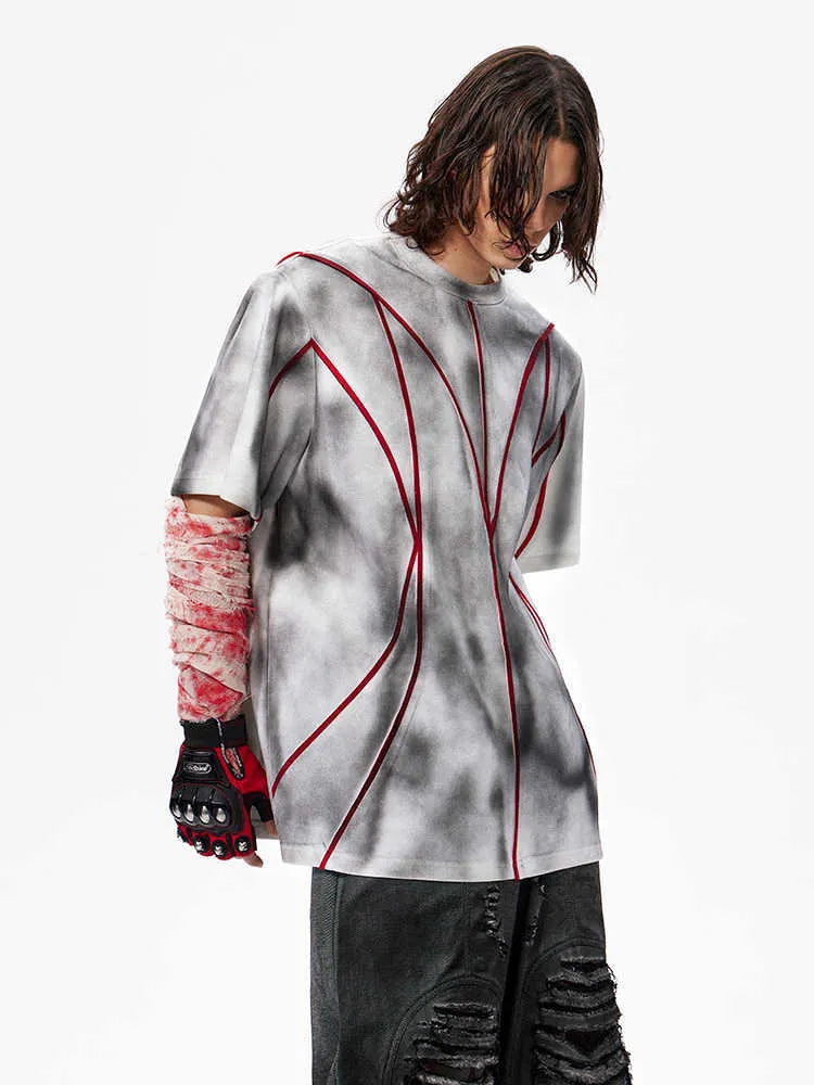 Short sleeve t-shirt with padded shoulders and three-dimensional line patchwork design on a round neck.