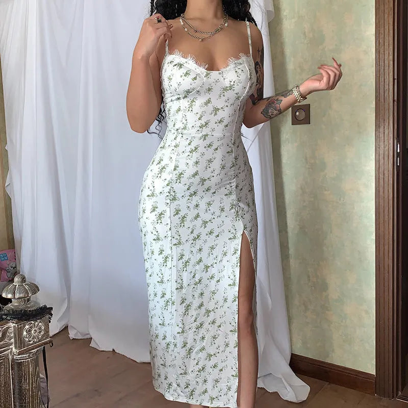 Women's blue long dress with white lace flower print, side slit, and thin adjustable suspender straps.