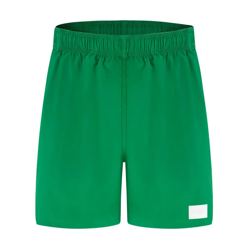 Men's quick-drying nylon sports shorts in green, shown with straight leg and elastic waist.