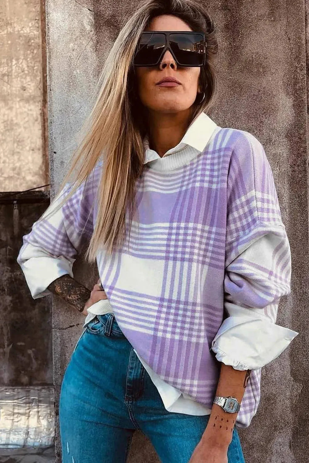Lilac plaid print loose fit long sleeve sweater with ribbed trim on a hanger.