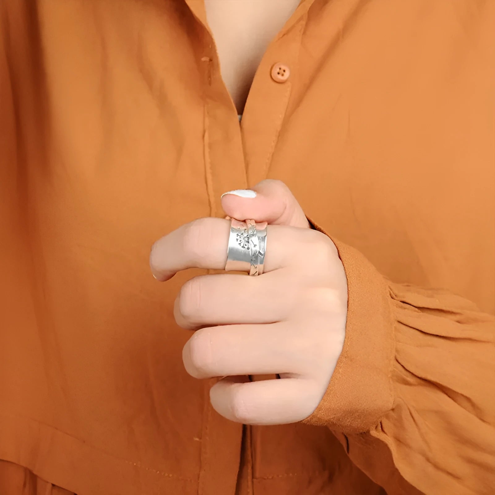 Silver electroplated rotatable flower ring showing floral design and European American sizes 7 to 11