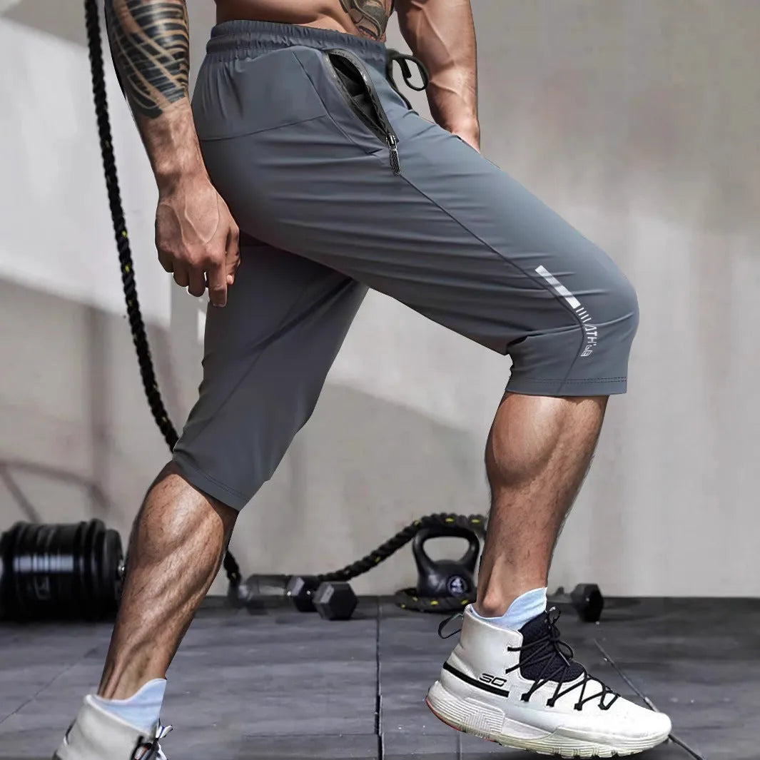Men's straight-leg cropped sports pants in quick-dry nylon fabric, shown in khaki colour.