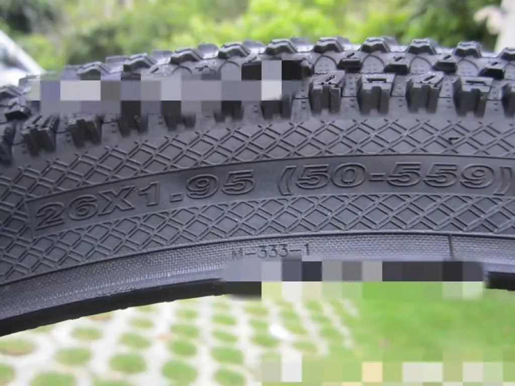 Mountain bike tyre with puncture-proof construction, shown in multiple sizes including 26x1.95 and 27.5x2.1