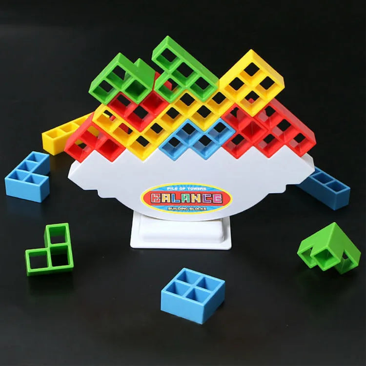 Plastic balance stacking game with 16 coloured building blocks, chassis, and base on a table
