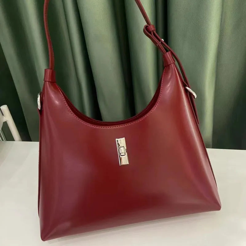 Genuine leather dumpling-shaped crossbody shoulder bag in apricot colour with a front sandwich pocket.