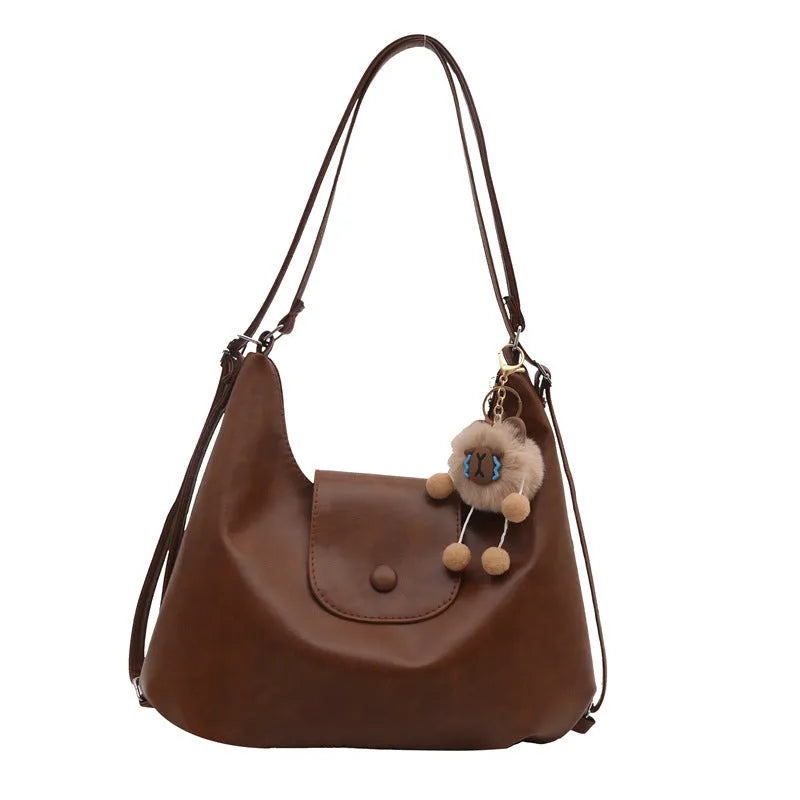 Women's PU leather commuter shoulder bag in horizontal square shape with single strap and optional pendant