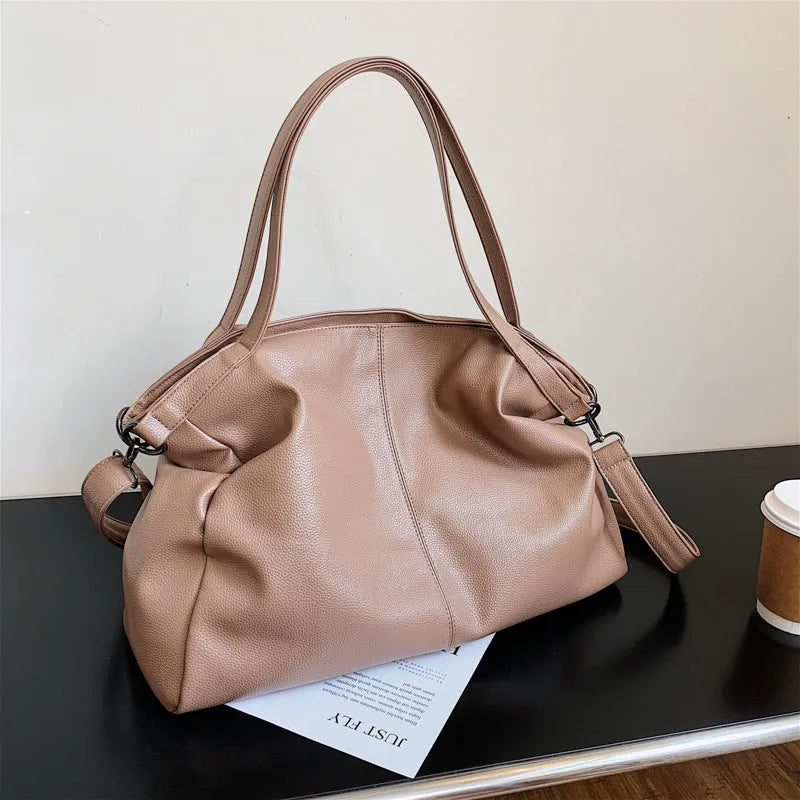Large soft PU leather messenger bag in khaki colour with adjustable shoulder strap and top handle.