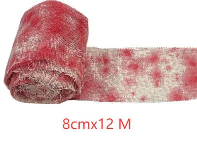 Roll of Halloween horror dyed gauze bandage in bloody red colour, shown with a loose end draped.