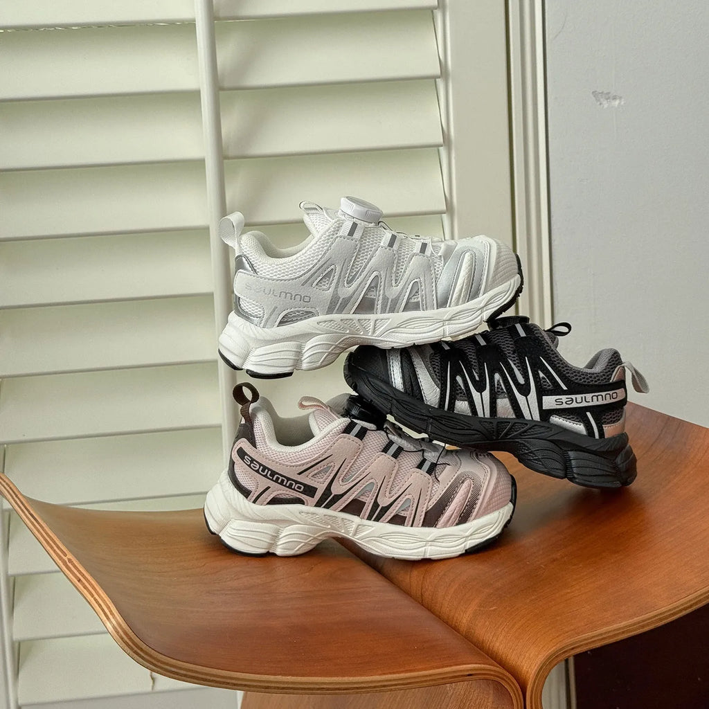 Girls lightweight casual sneaker in breathable mesh, available in black, beige, or pink.