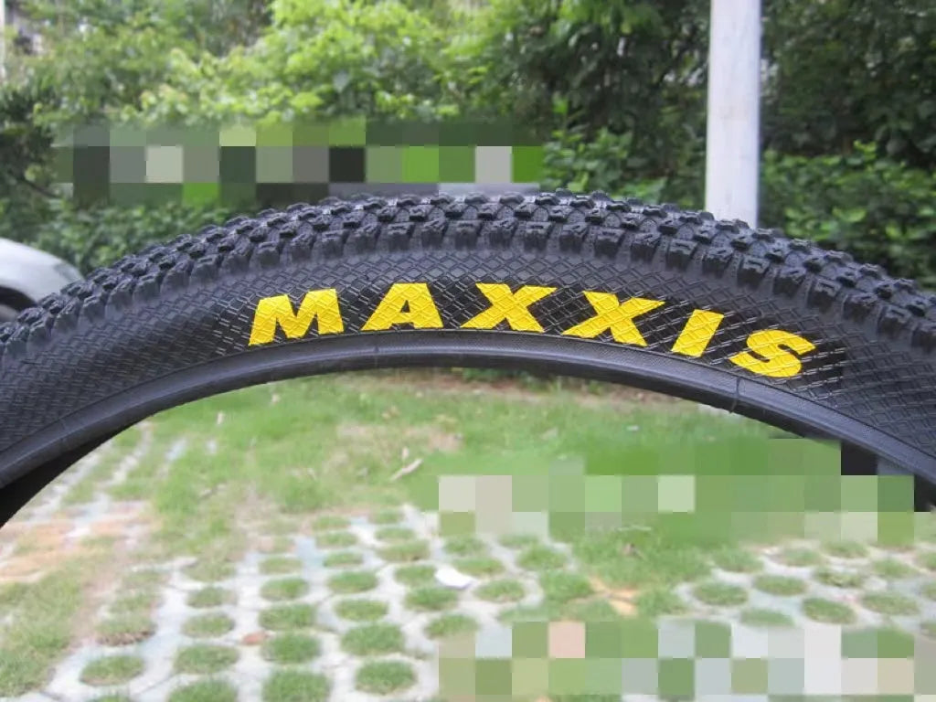 Mountain bike tyre with puncture-proof construction, shown in multiple sizes including 26x1.95 and 27.5x2.1