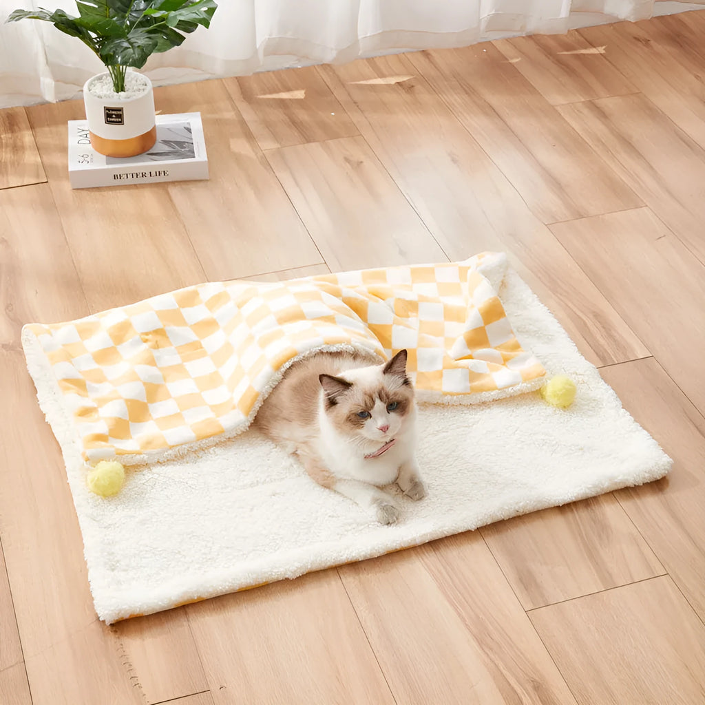 Green plaid plush pet blanket for dogs and cats on a sofa