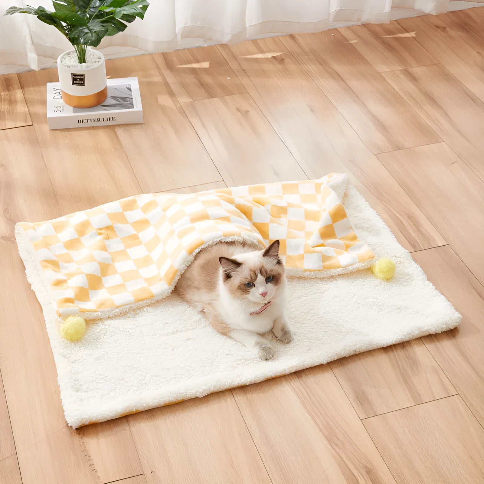 Green plaid plush pet blanket for dogs and cats on a sofa