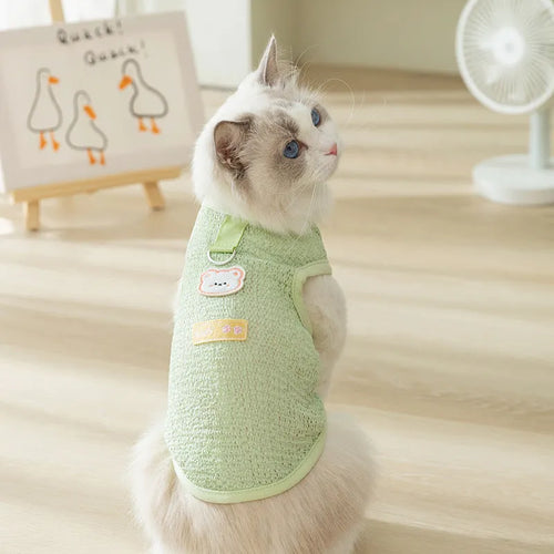 Green cat jumper with bear patch design showing breathable knitted fabric